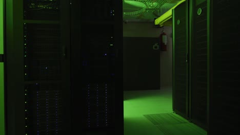 Green-control-lights-flashing-with-data-processing-on-computer-servers-in-tech-room