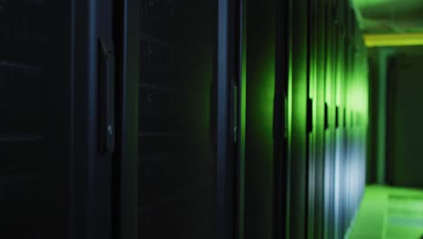Green-control-lights-reflected-on-computer-servers-in-tech-room