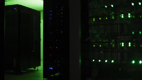 Close-up-of-green-control-lights-flashing-on-computer-servers-in-tech-room