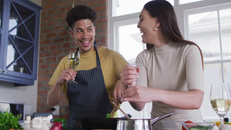 Feliz-Pareja-Birracial-Cocinando-Juntos-Y-Bebiendo-Vino-En-La-Cocina