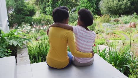 Happy-african-american-mother-and-daughter-embracing-in-garden