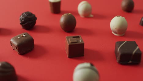 Black-and-white-chocolates-on-red-background-at-valentine's-day