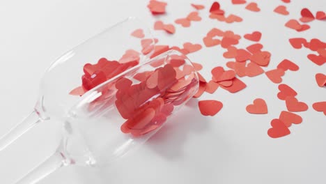 Champagne-glasses-with-paper-hearts-on-pink-background-at-valentine's-day