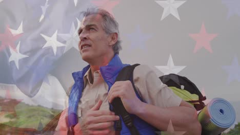Animation-of-american-flag-over-senior-caucasian-man-hiking-in-mountains