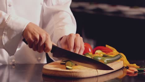 Chef-chopping-vegetables-on-wooden-board