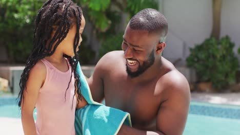 Happy-african-american-father-wiping-daughter-with-towel
