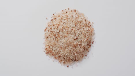 Video-of-pile-of-himalayan-pink-salt-on-white-background