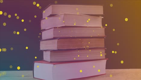 Animation-of-yellow-spots-over-books-on-black-background