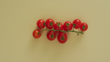 Video-of-fresh-cherry-tomatoes-with-copy-space-on-yellow-background