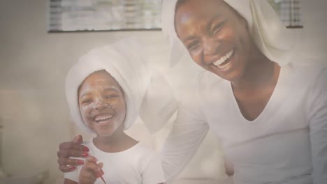 Animation-of-glowing-spots-over-happy-african-american-mother-and-daughter-with-face-mask