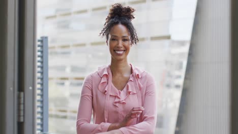 Portrait-of-happy-african-american-businesswoman-in-creative-office