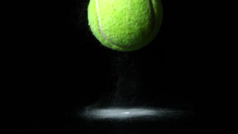Tennis-ball-falling-on-black-background
