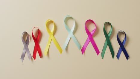 Video-of-close-up-of-cancer-ribbons-on-white-background