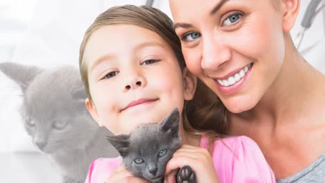 Animation-of-happy-caucasian-mother-and-daughter-with-cat-over-caucasian-female-vet-vaccinating-cat
