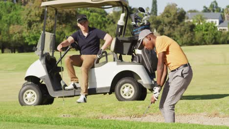 Video-of-diverse-male-friends-playing-golf-on-golf-field