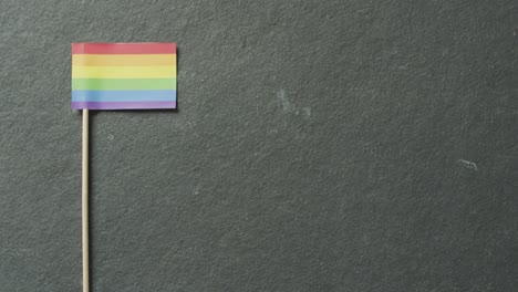 Video-of-rainbow-flag-lying-on-white-background