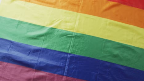 Video-of-rainbow-flag-lying-on-white-background