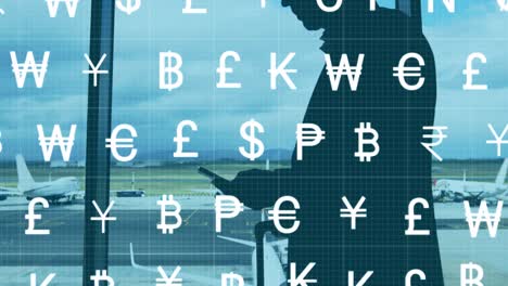 Animation-of-currency-symbols-over-caucasian-businessman-at-airport