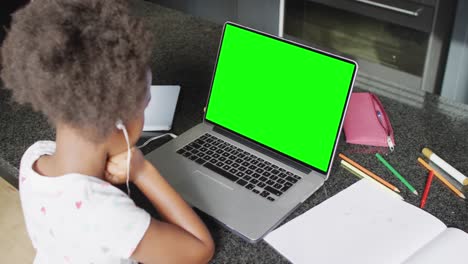 African-american-girl-using-laptop-for-video-call,-with-copy-space-on-screen
