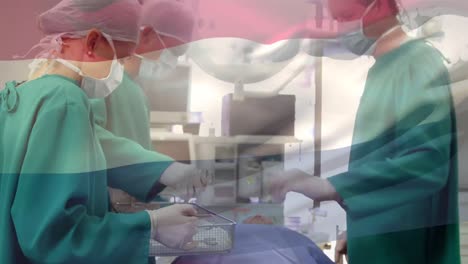Animation-of-flag-of-russia-over-diverse-male-and-female-surgeons-during-operation