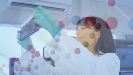 Animation-of-dna-helix-rotating-over-asian-female-scientist-checking-test-tube-rack-in-laboratory