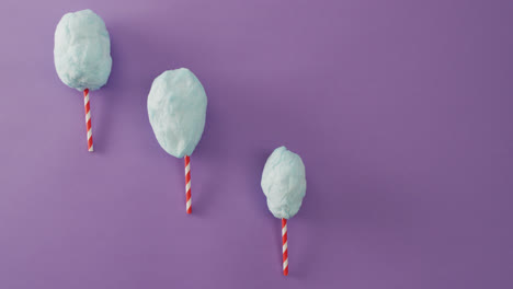 Video-of-marshmallows-on-sticks-lying-on-purple-surface