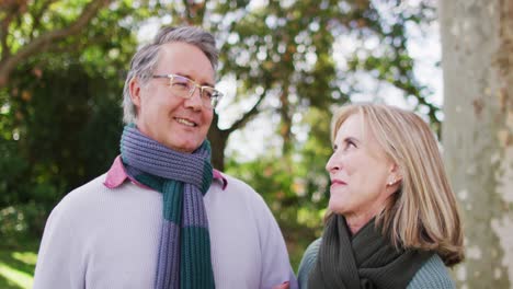 Video-portrait-of-happy-caucasian-senior-husband-and-wife-talking-and-smiling-in-autumn-garden