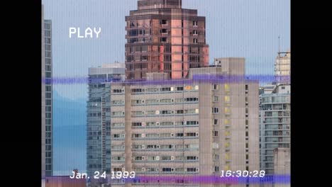 Animation-of-vhs-glitch-effect-over-tall-buildings-in-background