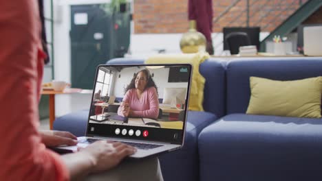 Animation-of-biracial-woman-having-video-call-on-laptop