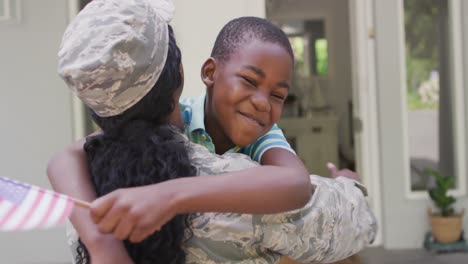 Montage-of-african-american-female-and-male-soldiers-embracing-children