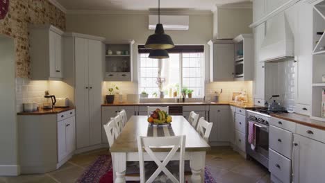 General-view-of-kitchen-interior-with-cupboards,-countertop-and-table