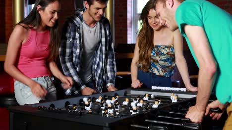 Happy-friends-playing-table-football