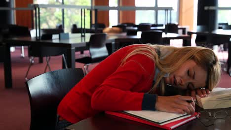 Mature-student-sleeping-at-study-table