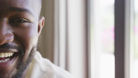Videoporträt-Des-Halben-Gesichts-Eines-Glücklichen-Afroamerikanischen-Mannes,-Der-Zu-Hause-Lächelt,-Mit-Kopierraum
