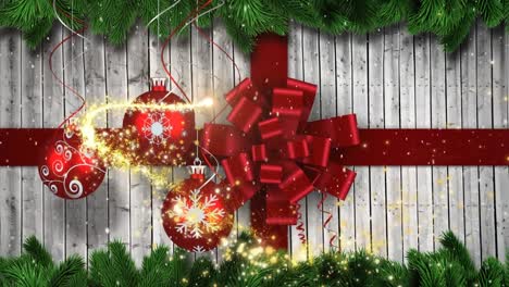 Animation-of-shooting-star-over-christmas-bauble-and-ribbon-decoration-on-wooden-surface