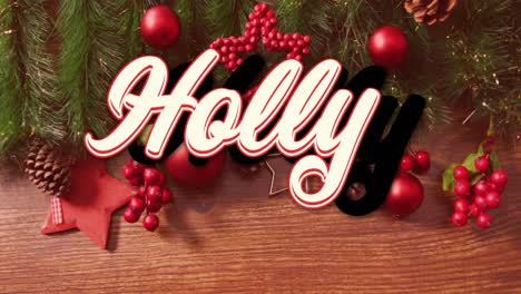 Animation-of-holly-text-banner-over-christmas-decorations-and-green-branches-on-wooden-surface