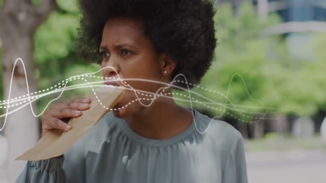 Animation-of-business-data-over-african-american-woman-eating-sandwich