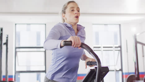 Video-of-determined-caucasian-woman-on-exercise-bike-working-out-at-a-gym