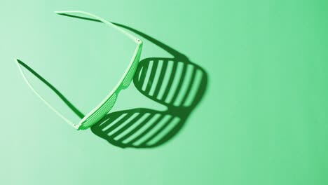 Video-of-st-patrick's-green-glasses-with-copy-space-on-green-background