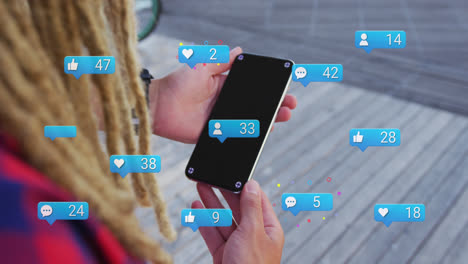 Animation-of-social-media-icons-with-numbers-over-biracial-man-using-smartphone