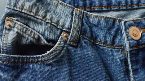 Close-up-of-jeans-on-grey-background-with-copy-space