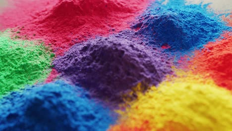 Video-of-close-up-of-multi-coloured-powders-with-copy-space-on-white-background