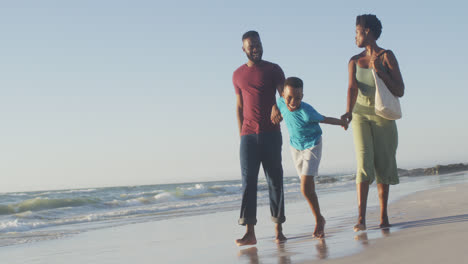 Video-of-happy-african-american-family-having-fun-on-beach