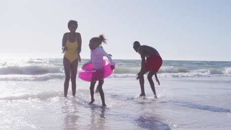 Video-of-happy-african-american-family-having-fun-o-beach