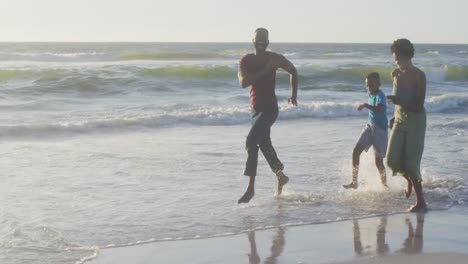 Video-of-happy-african-american-family-having-fun-on-beach