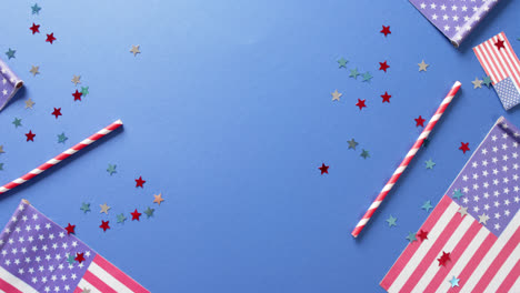National-flags-of-usa-with-stars-and-straws-lying-on-blue-background-with-copy-space