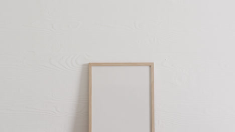 Wooden-frame-with-copy-space-on-white-background-and-white-wall