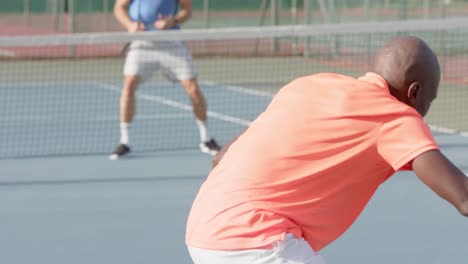 Caucasian-male-tennis-player-celebrating-point-against-diverse-opponent-on-court-in-slow-motion