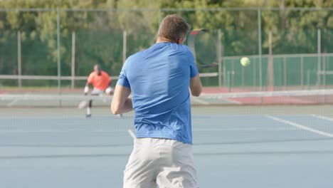 Caucasian-male-tennis-player-celebrating-point-against-diverse-opponent-on-court-in-slow-motion