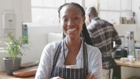 Portrait-of-african-american-female-coffee-shop-owner-at-work,-slow-motion